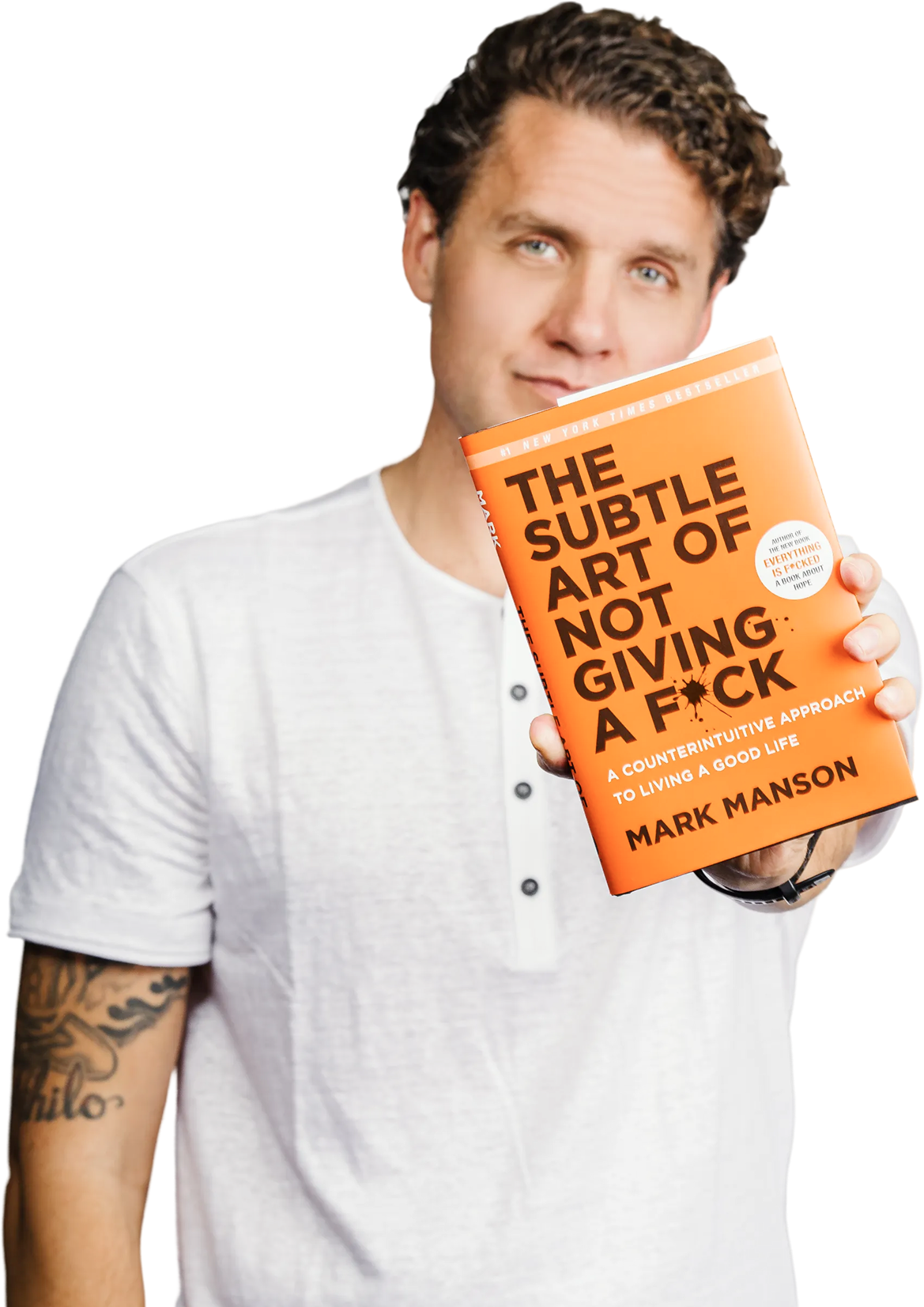 Mark Manson holding The Subtle Art of Not Giving a F*ck